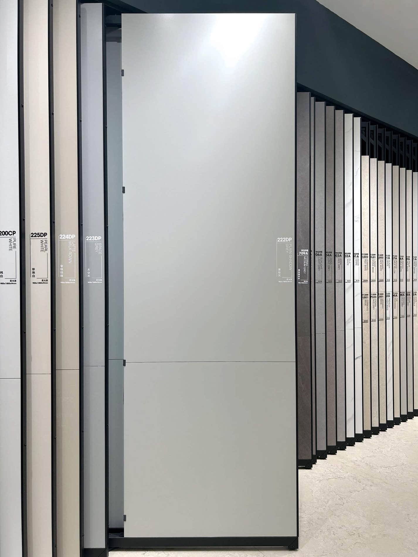 Dove gray sintered stone slab shown on a showroom display rack