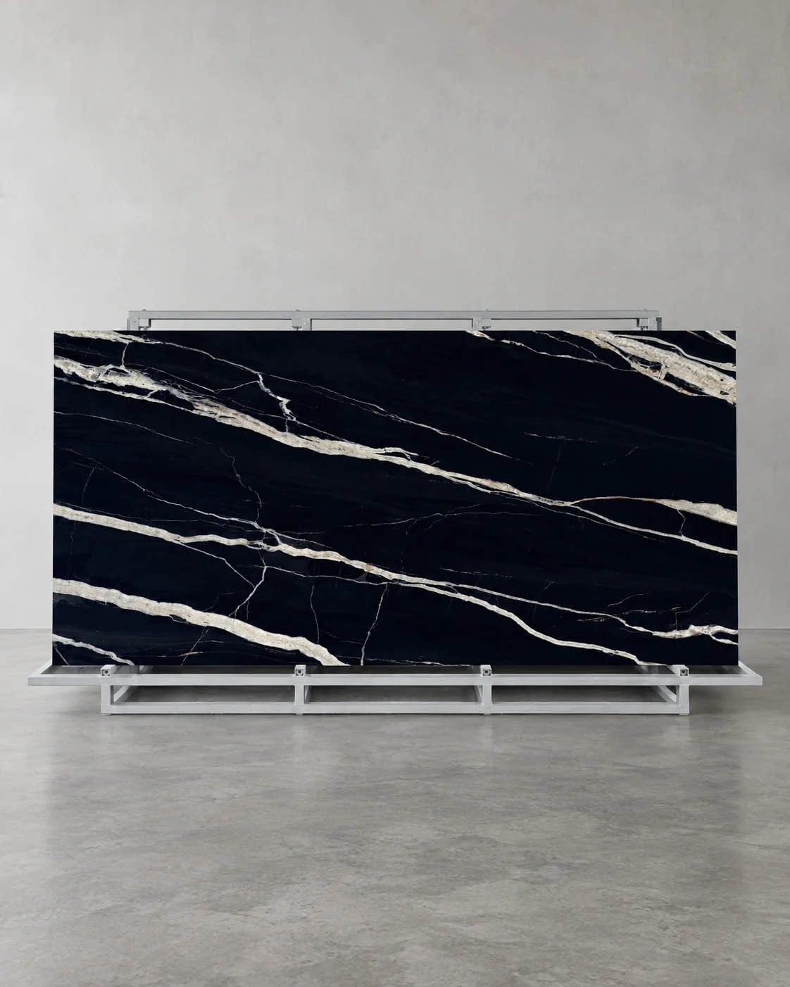 Top-Level Black Marquina full sintered stone slab on an A-frame with broad ivory veins