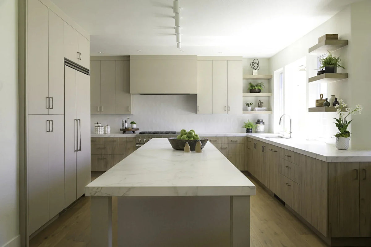Dekton Rem warm white countertop and island in a light wood kitchen