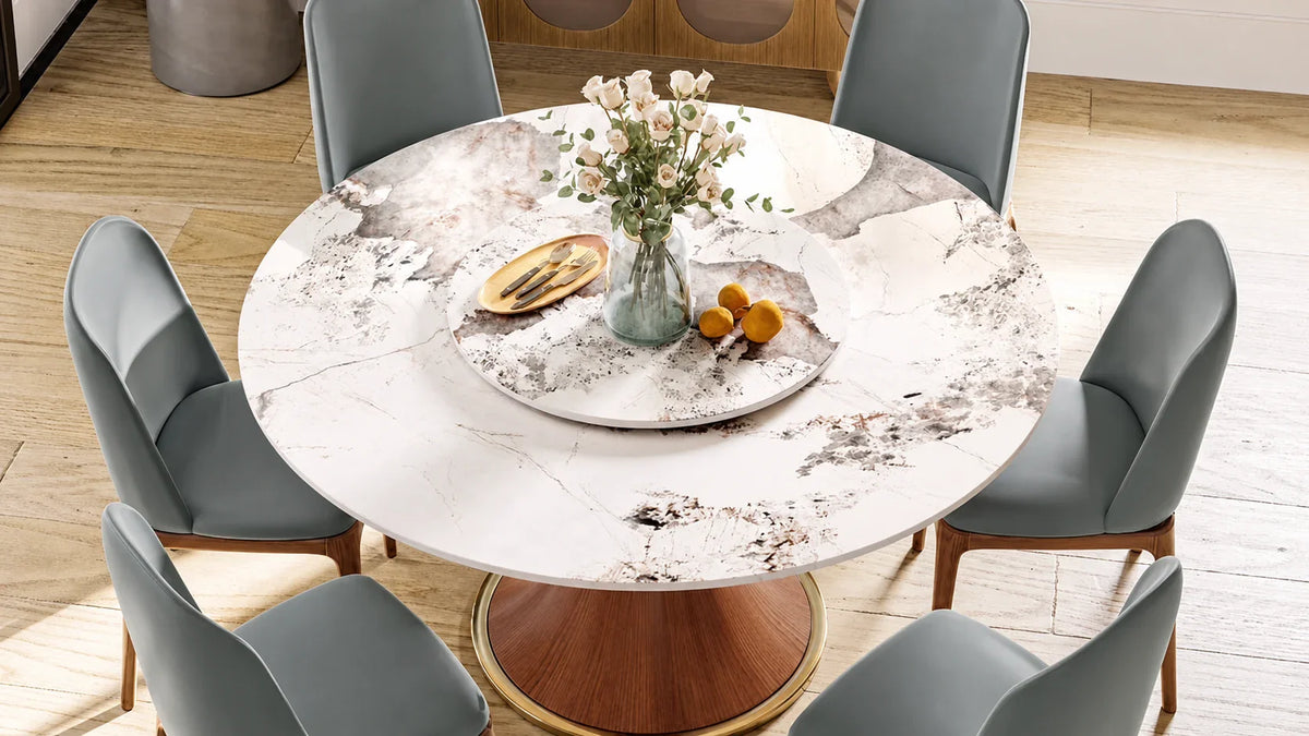 Round sintered stone dining table with a raised matching Lazy Susan and six grey chairs