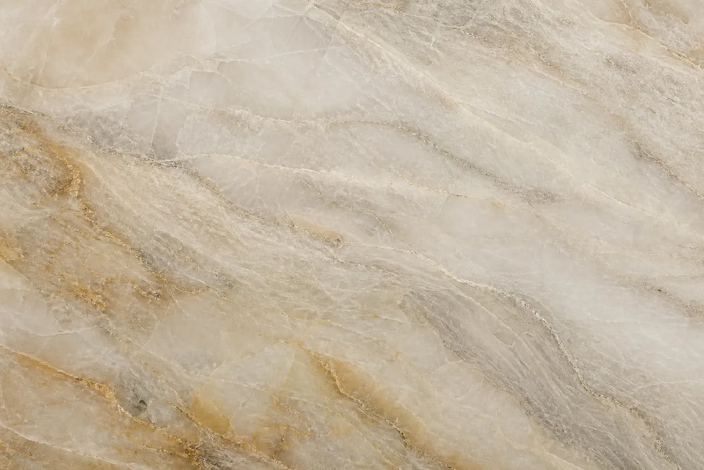 Close-up of a warm Taj Mahal quartzite-style texture with cream, taupe and soft gold movement