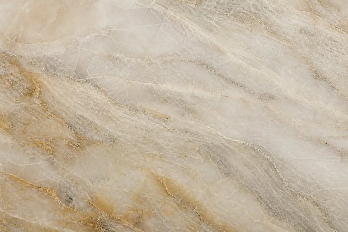 Close-up of a warm Taj Mahal quartzite-style texture with cream, taupe and soft gold movement
