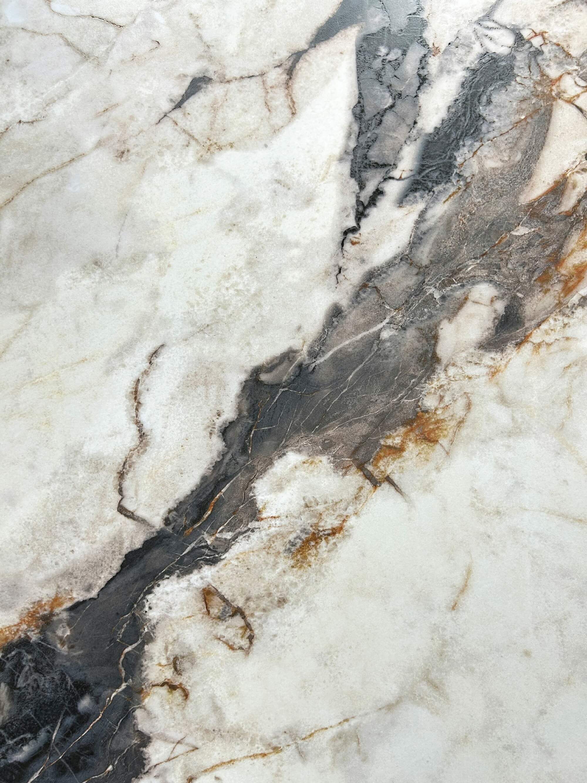 White crystalline breccia-look texture with charcoal and warm-brown veins