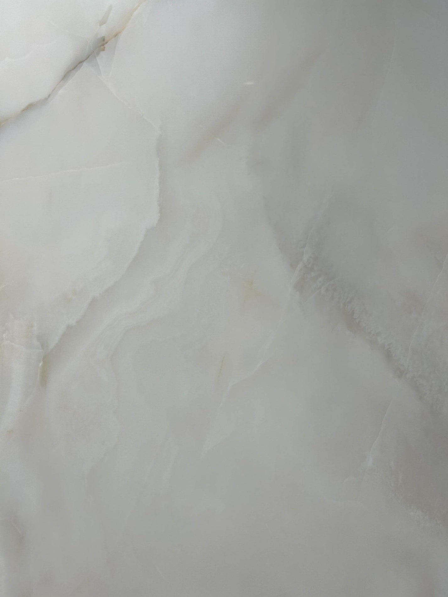 Close-up of soft-polished ivory jade-like sintered stone texture