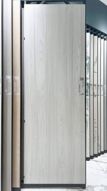 Light grey wood-look slab on a showroom rack — Griffith Light Grey Wood Look sintered stone
