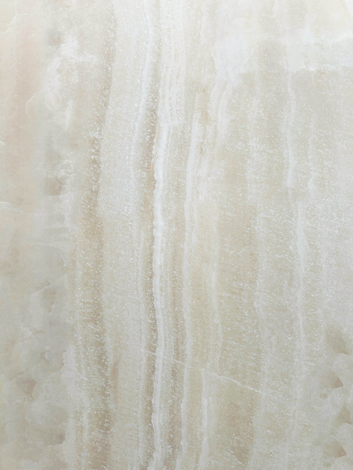 Close-up of soft-polished cream crystalline onyx-look texture
