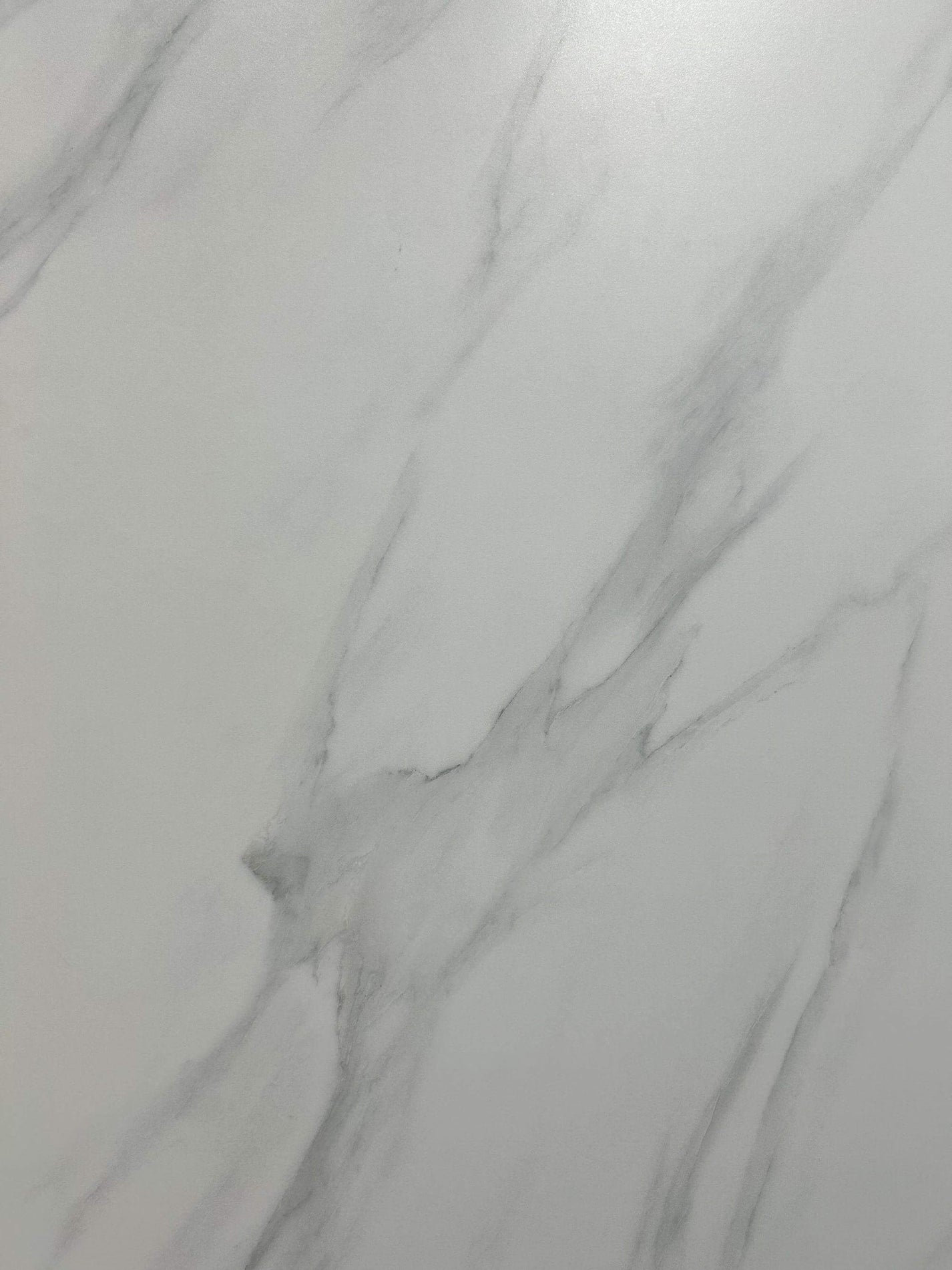 Крупный план плиты из спеченного камня Carrara White с прожилками белого камня, вид спереди
