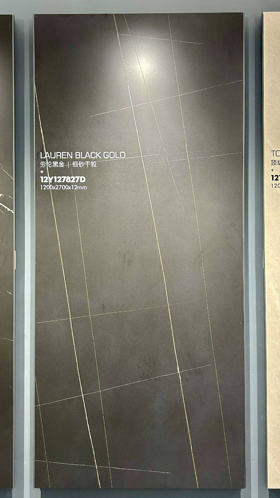 Laurent Black Gold Marble Look sintered stone slab shown upright in a showroom display