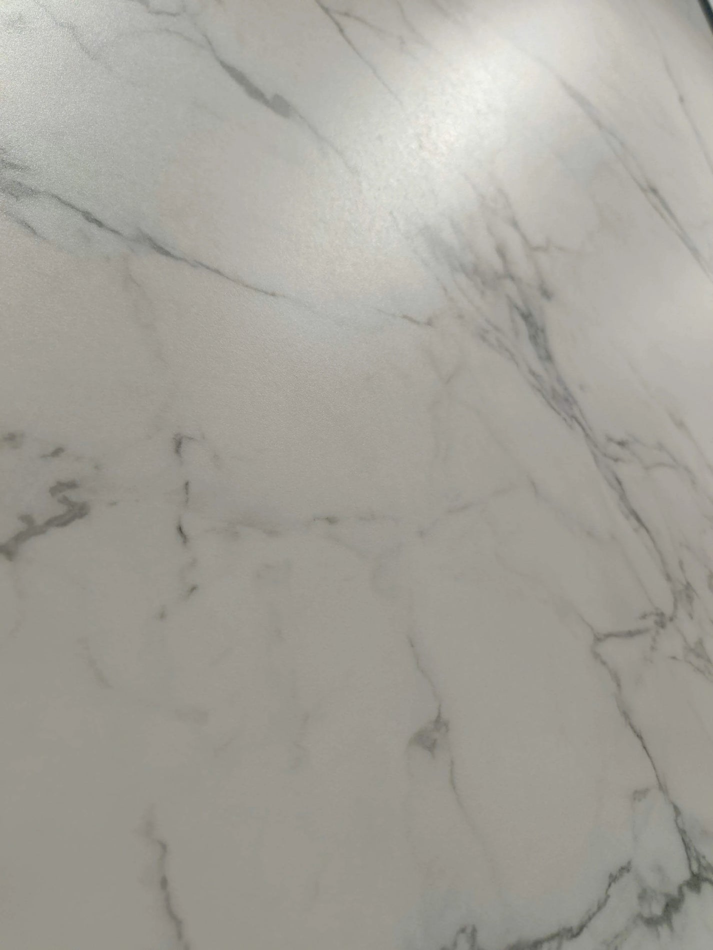Alabaster surface detail with fine gray cartographic veins