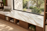 Alice Gold full-body sintered stone surface above wood shelving beside a library window seat
