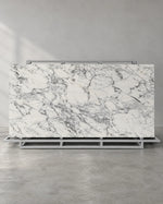 Balop white marble-look sintered stone slab on a complete A-frame in a showroom