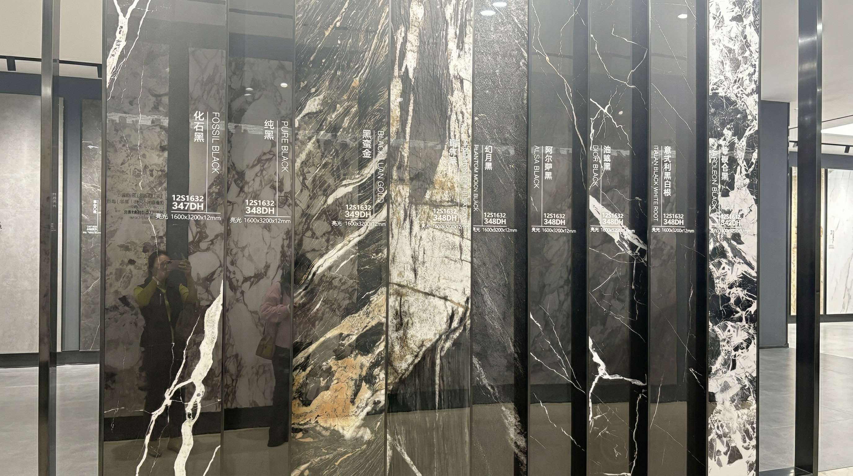 Dark marble look sintered stone slab samples displayed in a showroom