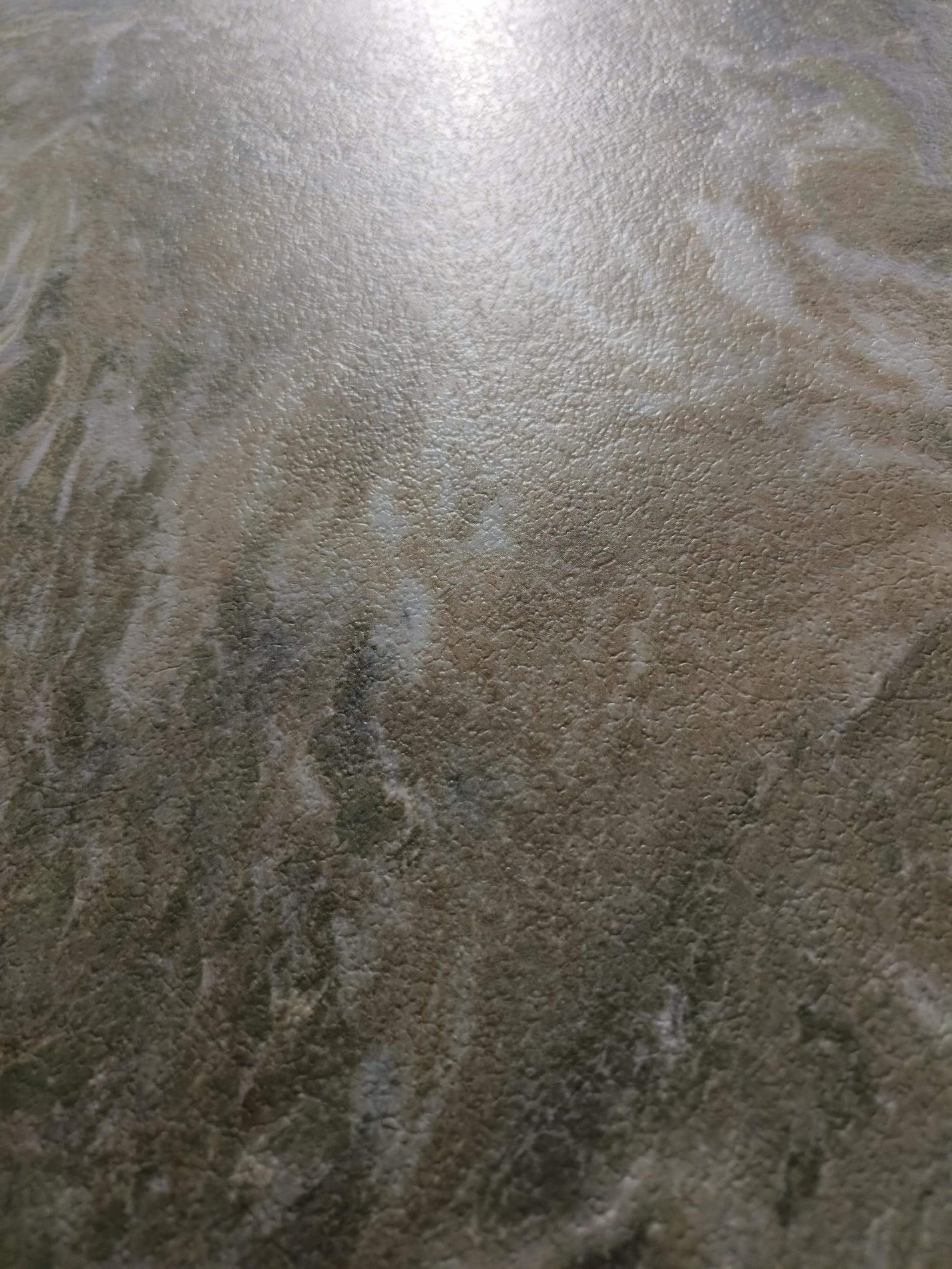 Warm beige and olive-grey section of the jade-look sintered stone surface
