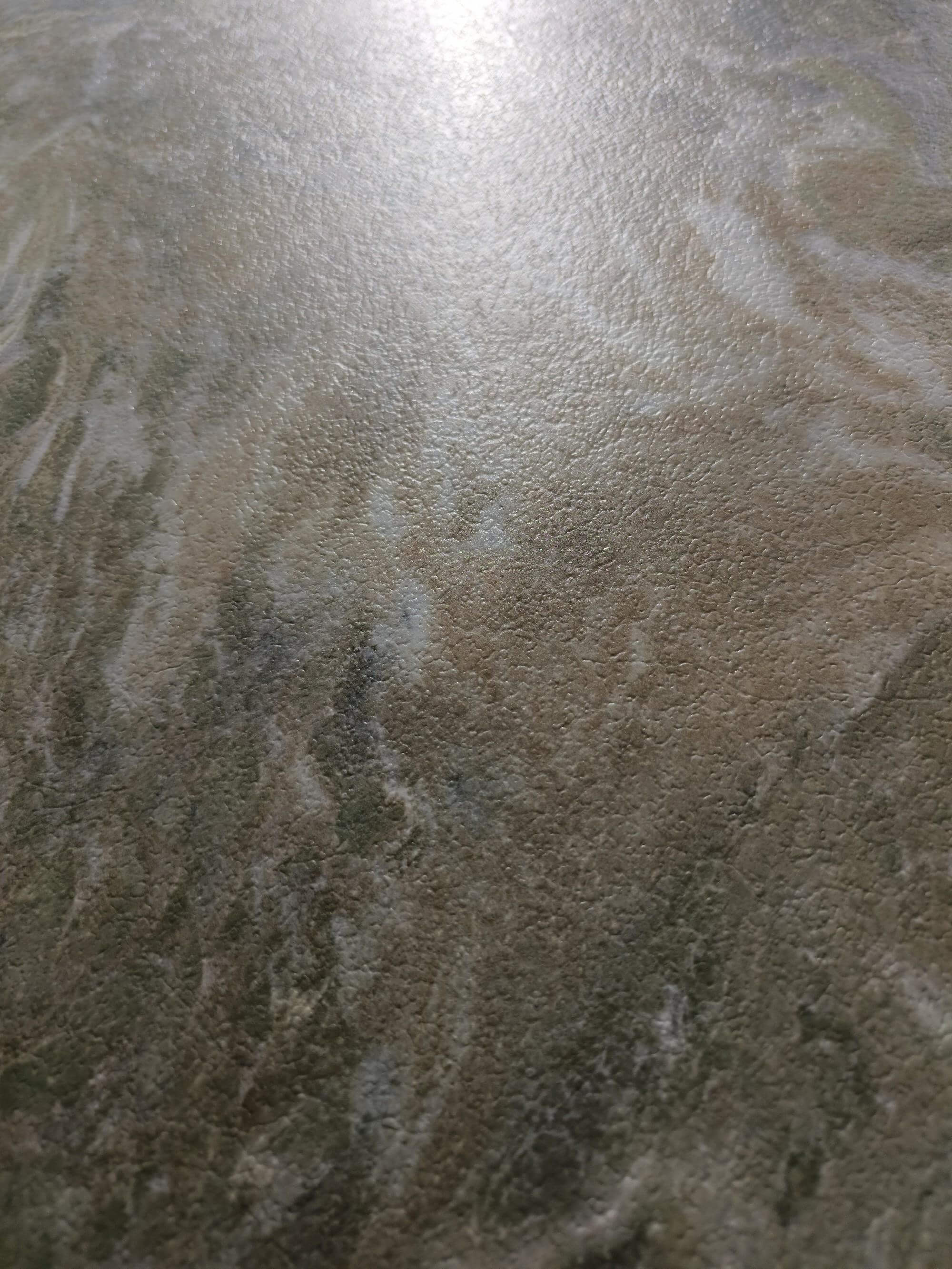 Warm beige and olive-grey section of the jade-look sintered stone surface