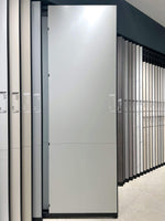 Dove gray sintered stone slab shown on a showroom display rack