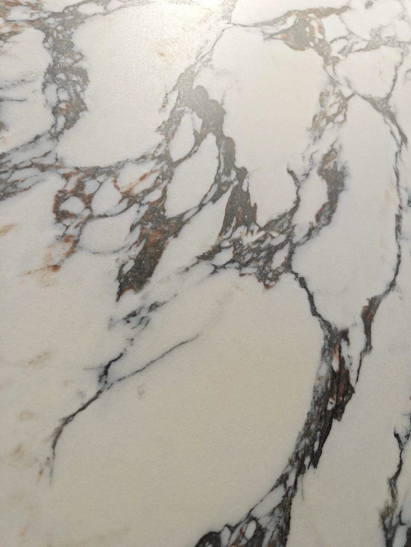Close-up of Exquisite Bulgari warm white surface with charcoal breccia veining