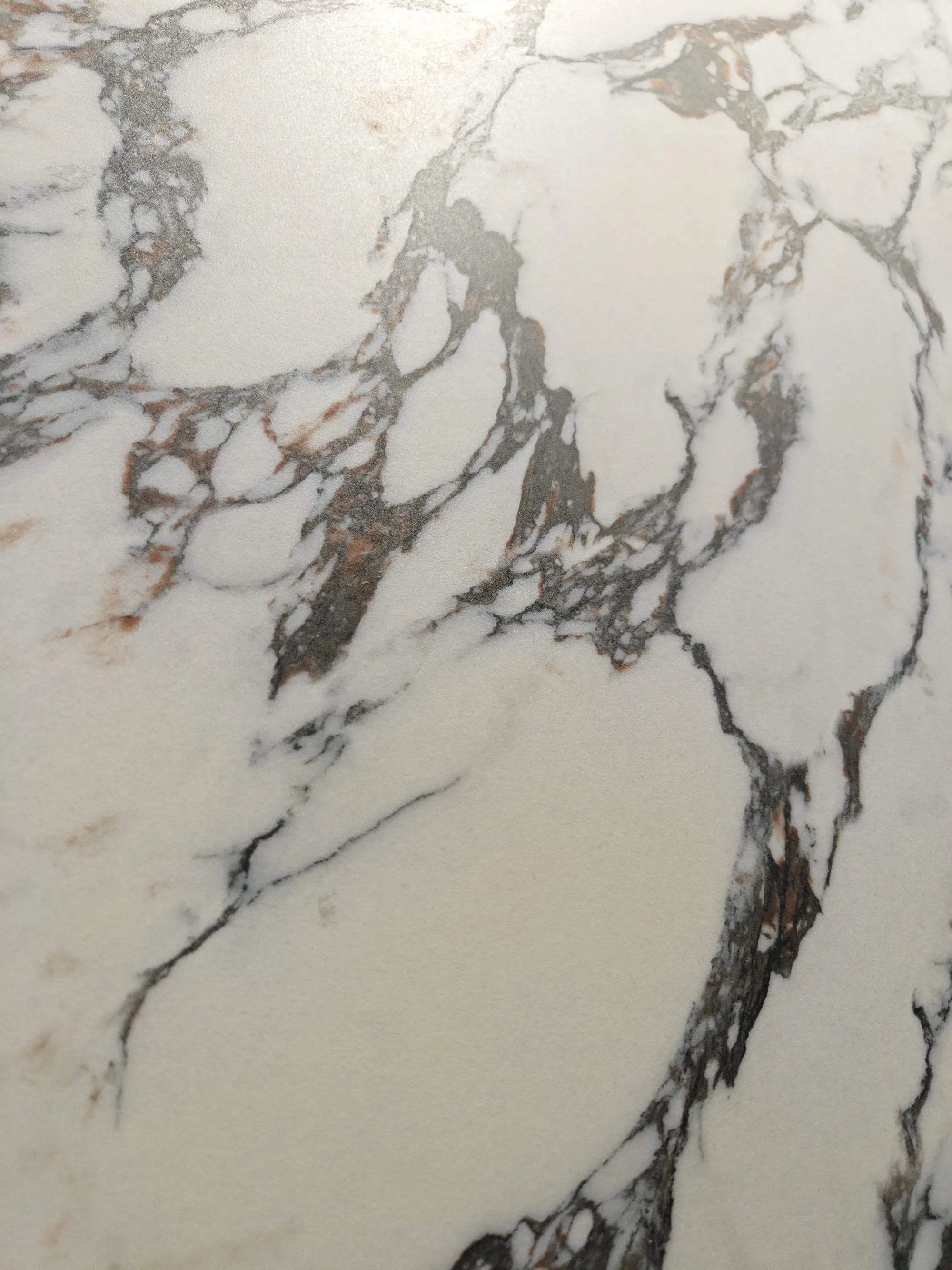 Close-up of Exquisite Bulgari warm white surface with charcoal breccia veining