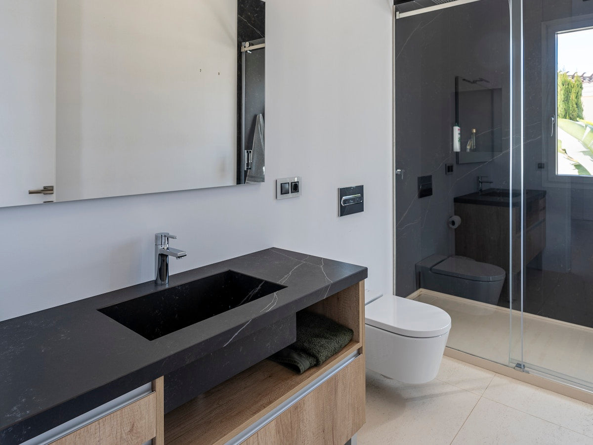 Dark concrete-look Funtek sintered stone bathroom vanity and shower wall project
