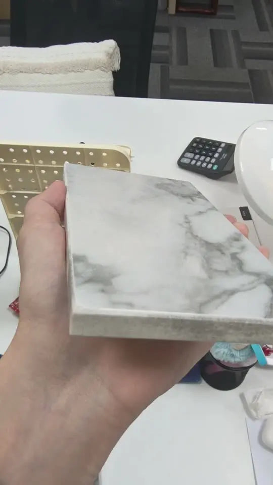 Sintered stone sample being reviewed by hand