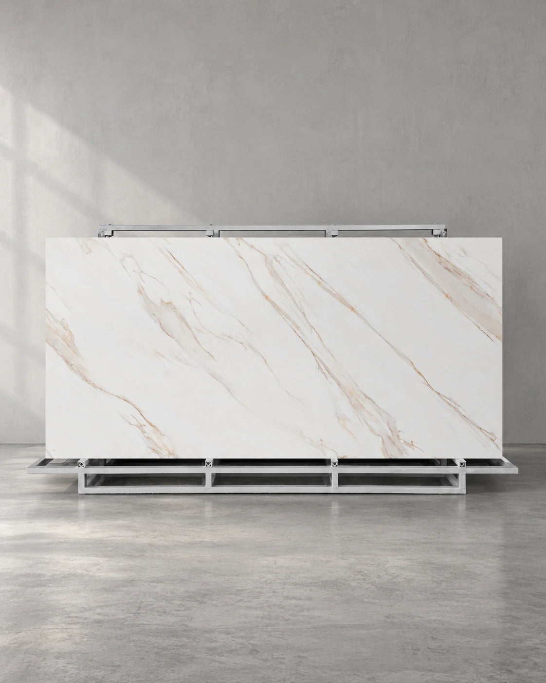 Gadal Fish Maw Gold full sintered stone slab on an A-frame with fine diagonal gold veins