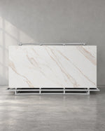 Gadal Fish Maw Gold full sintered stone slab on an A-frame with fine diagonal gold veins