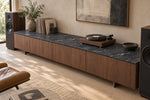 Gucci Black sintered stone console top with flowing pale veins in a listening room
