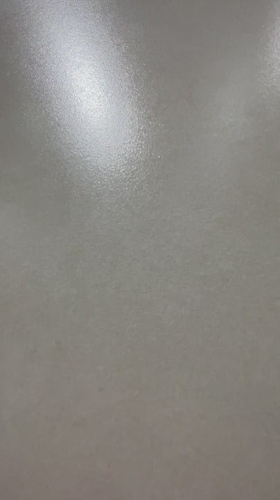 Showroom pan across the Bellamoum Apricot matte cement-look sintered stone surface