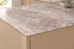 Sakura Pink sintered stone countertop with a thin 12mm edge above light wood cabinets
