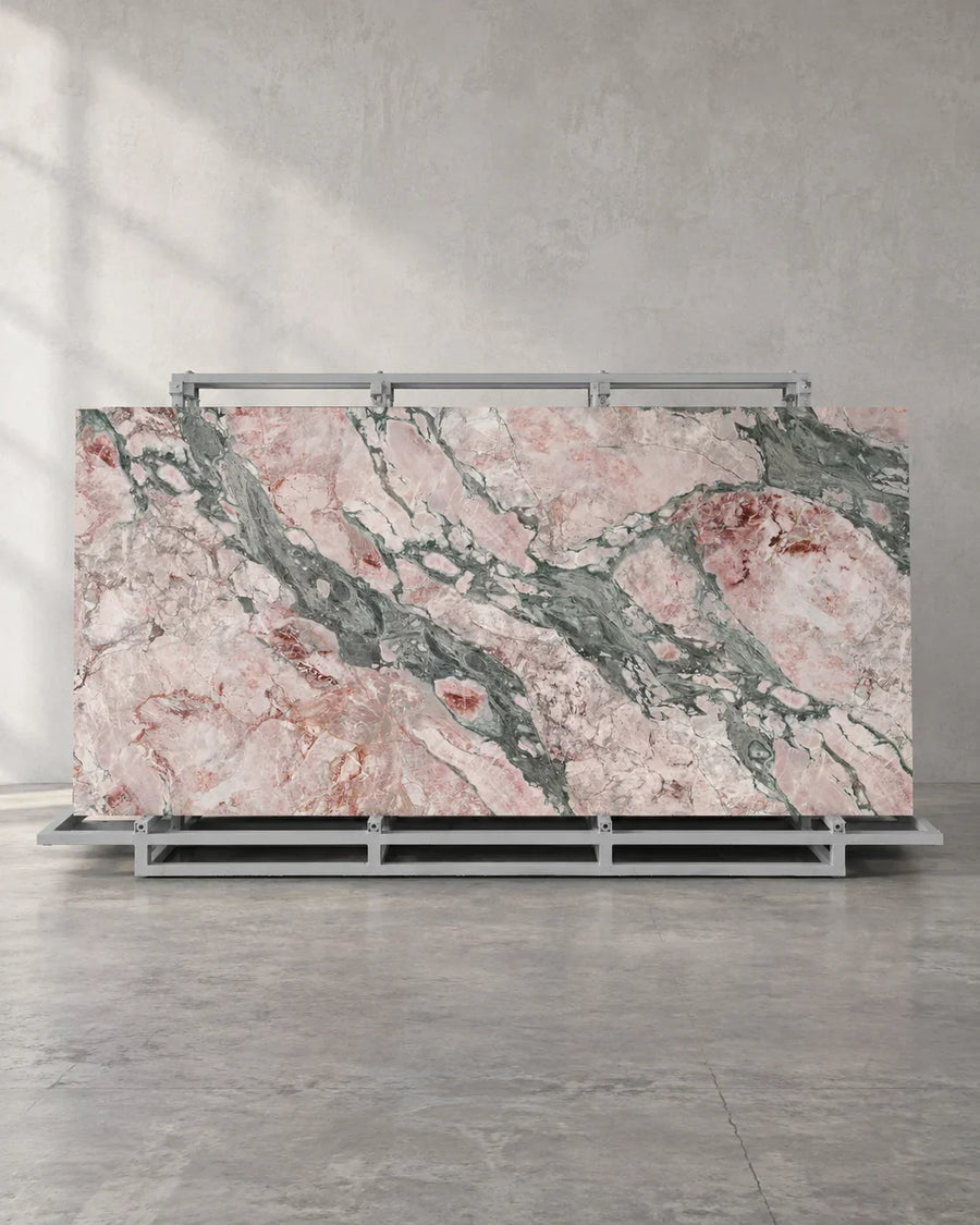 Seasons Pink full-body sintered stone slab and complete A-frame in a naturally framed showroom