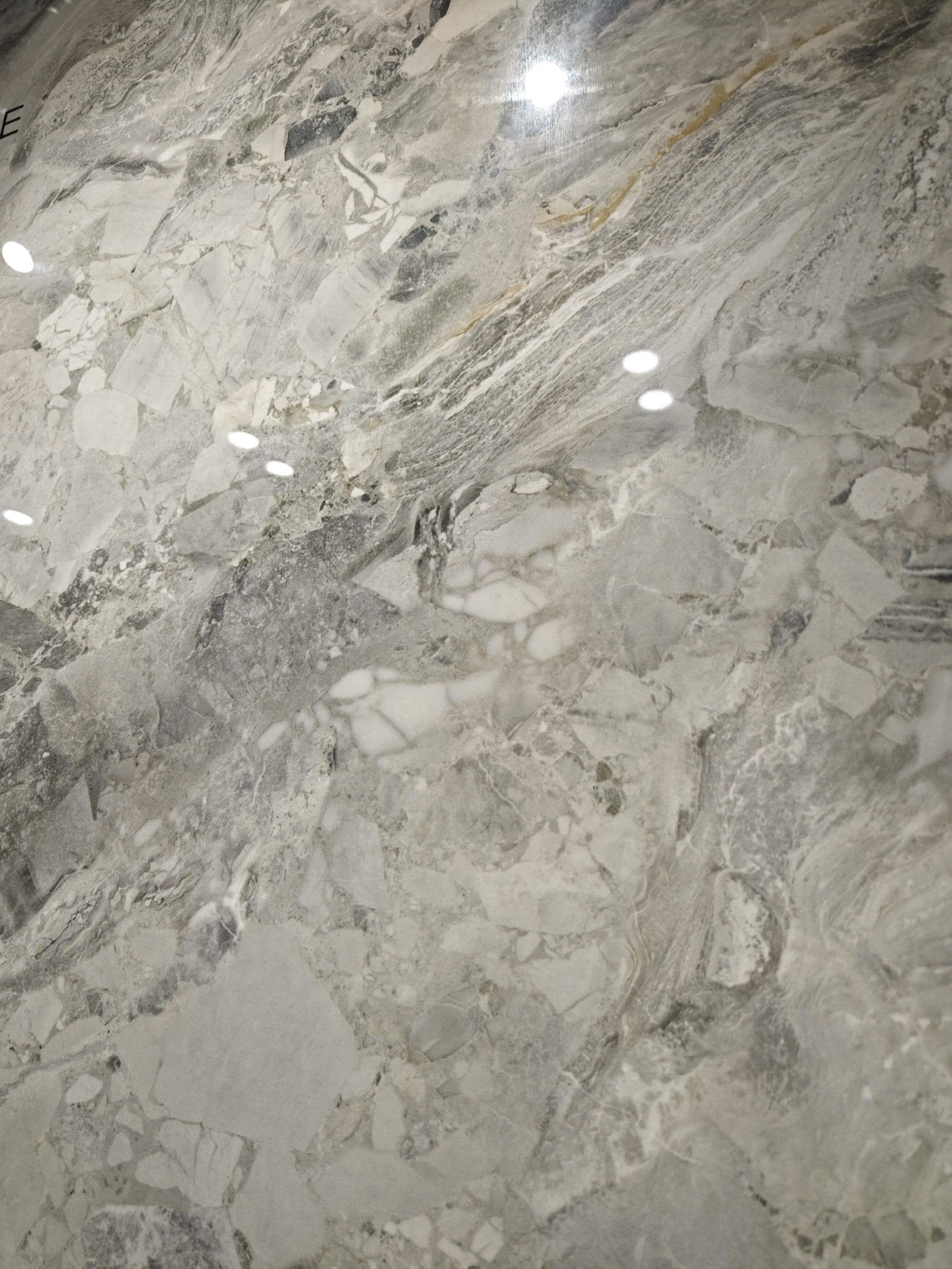 Detailed Sicilian Jade surface showing layered grey movement and subtle warm-gold hairlines