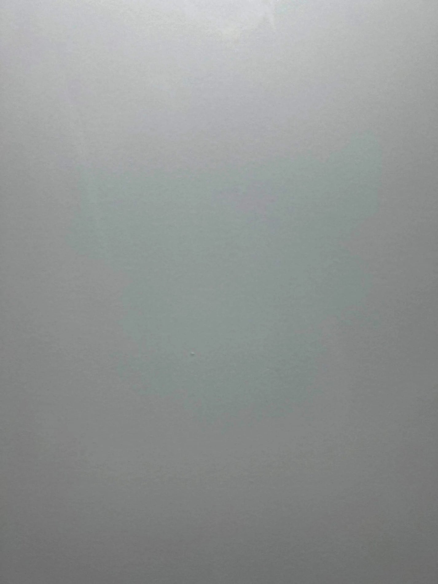 Full surface view of muted silver gray sintered stone with subtle clouded texture