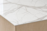 Super Snow White sintered stone countertop with a slim 12 mm exposed edge above oak cabinetry