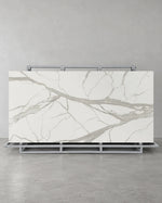 Super Snow White full slab with broad pale grey veins on a complete steel A-frame