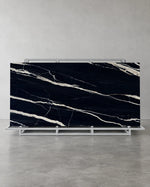 Top-Level Black Marquina full sintered stone slab on an A-frame with broad ivory veins