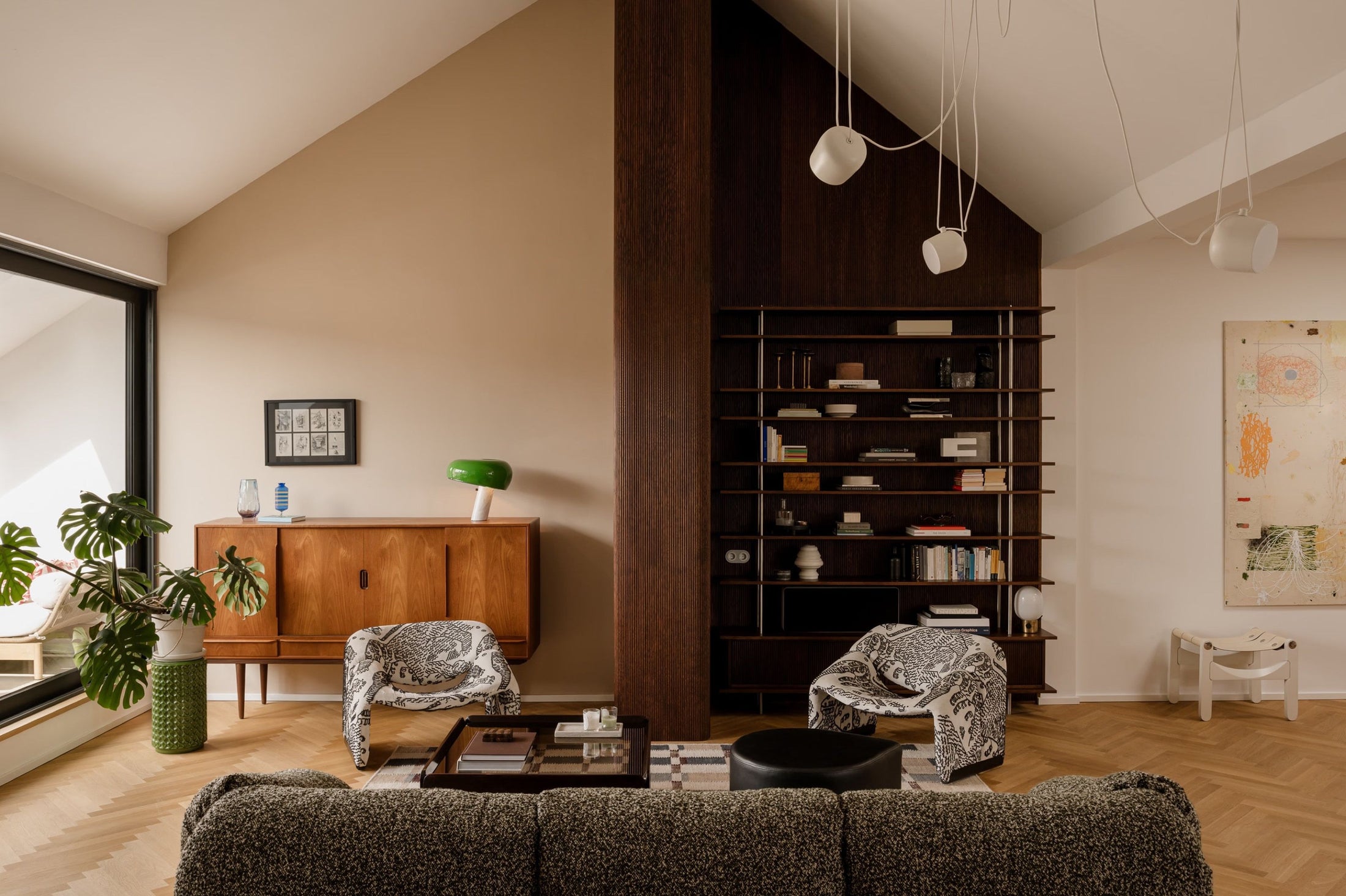 The dark architectural spine had to align across wall planes, shelves and furniture-scale details while the surrounding surfaces stayed deliberately calm.