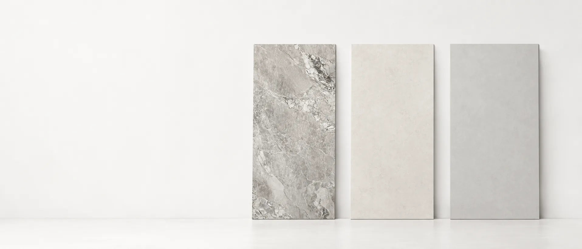 Concrete and microcement look sintered stone slabs in light grey, greige and ash grey