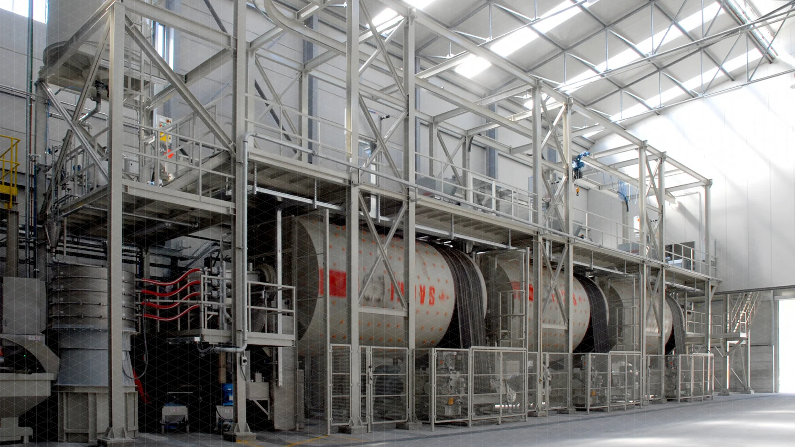 Industrial ball mills grinding minerals with water to make slurry