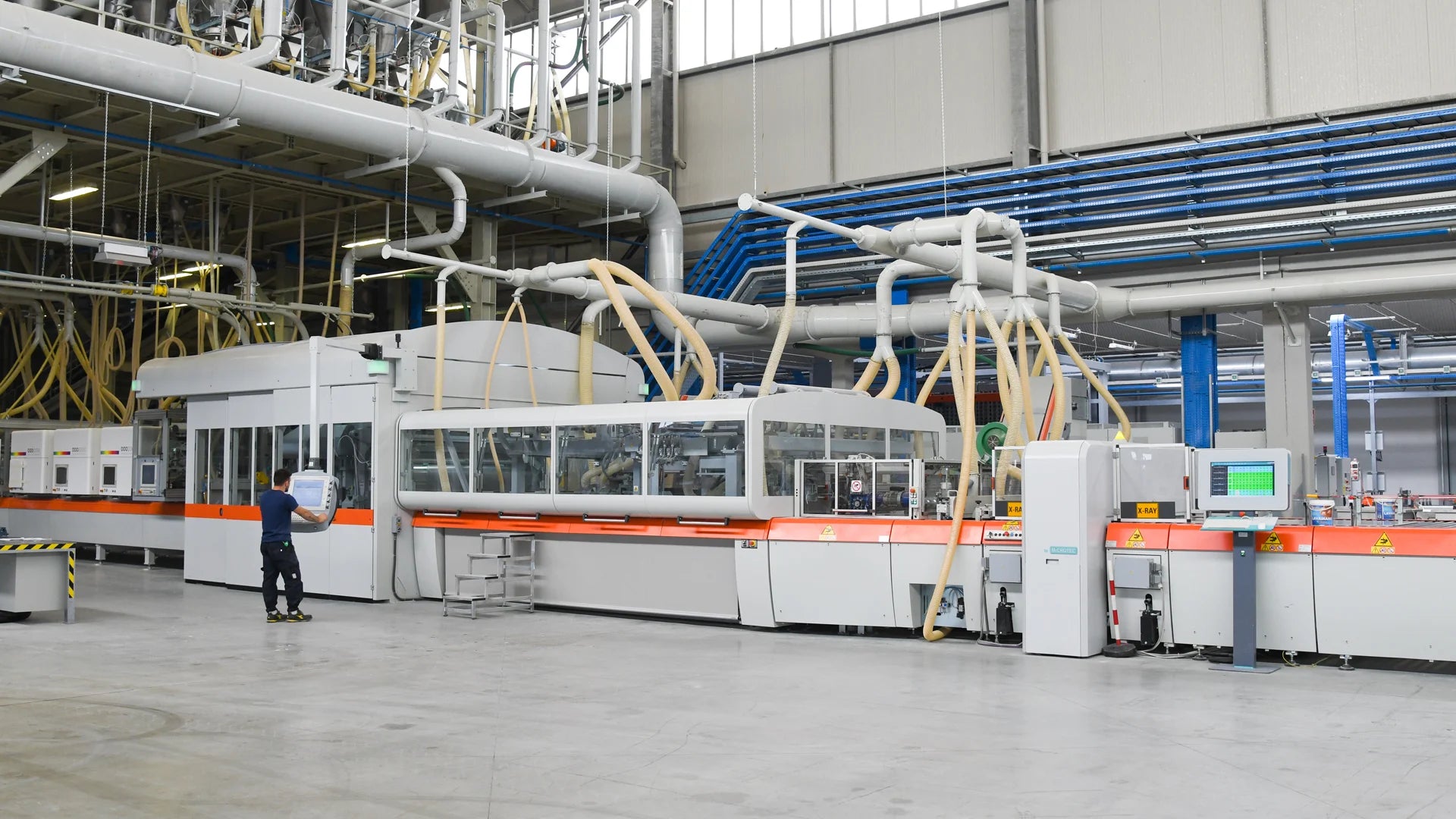 Continuous press compacting mineral granules into an unfired slab body