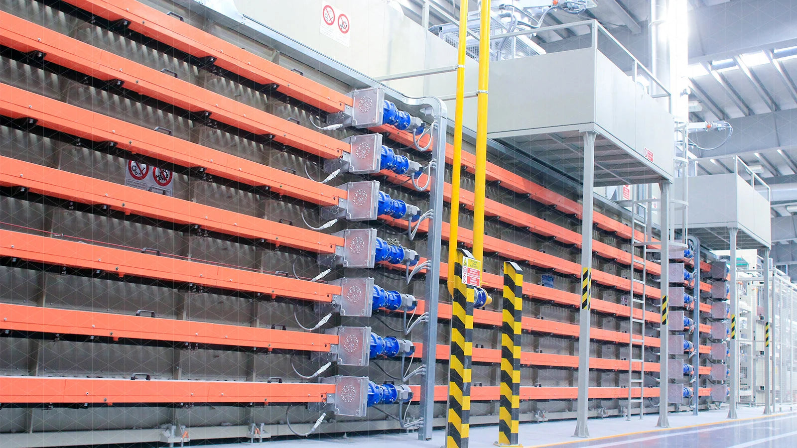 Unfired slab bodies moving through controlled industrial drying equipment