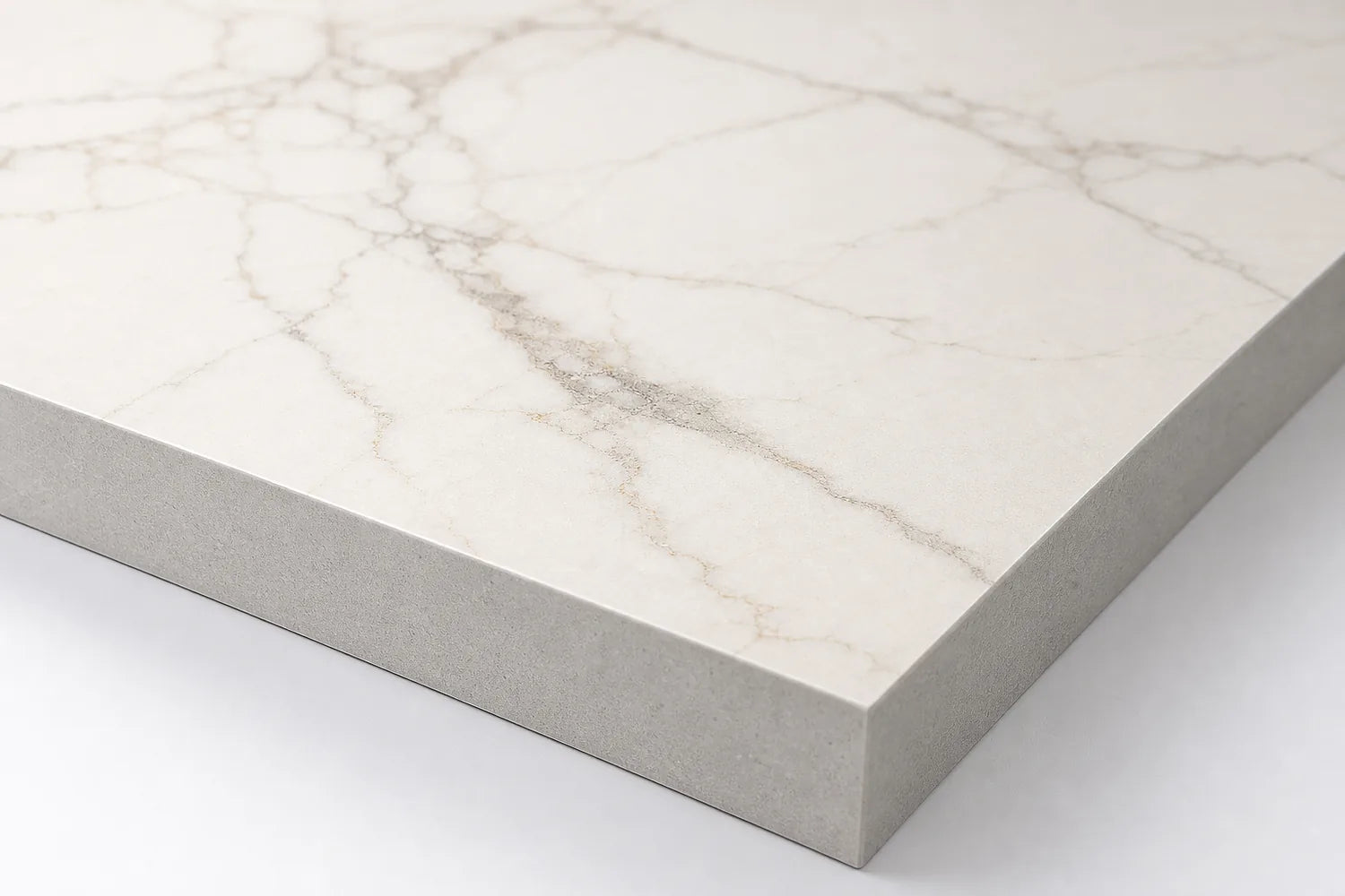 Printed marble-look surface above a uniform sintered stone body edge